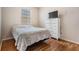 Cozy bedroom features wood laminate flooring and a bright window at 10435 Peppergrass Ct, Trinity, FL 34655