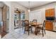 Dining area with a wooden table, tile floors, and sliding door leading to the outside at 10435 Peppergrass Ct, Trinity, FL 34655