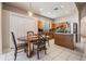 Dining area with tile flooring, wooden table, and stainless steel refrigerator at 10435 Peppergrass Ct, Trinity, FL 34655