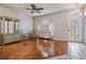 Inviting room with bright windows, wooden floors, and a decorative entry door at 10435 Peppergrass Ct, Trinity, FL 34655