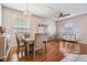 Formal dining room boasts wood flooring, elegant chandelier, and stylish furniture at 10435 Peppergrass Ct, Trinity, FL 34655