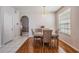 Dining area with wood floors, elegant decor, and a view of the living room at 10435 Peppergrass Ct, Trinity, FL 34655