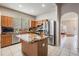 Kitchen boasting an island, stainless steel appliances, and natural wood cabinets at 10435 Peppergrass Ct, Trinity, FL 34655