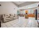 Open-concept living room and kitchen with tile flooring and vaulted ceilings at 10435 Peppergrass Ct, Trinity, FL 34655
