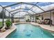 Backyard pool featuring a brick surround and full screen enclosure at 10435 Peppergrass Ct, Trinity, FL 34655