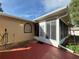 Enclosed back porch featuring a screen door, tile flooring, and views of the yard at 10458 Clingman St, Spring Hill, FL 34608