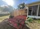Cozy backyard featuring a red brick patio, storage shed, and views of the home's exterior at 10458 Clingman St, Spring Hill, FL 34608