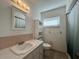 Bright bathroom with a white vanity, tile flooring, and a shower with a curtain at 10458 Clingman St, Spring Hill, FL 34608