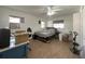 Spacious bedroom with wood floors, a ceiling fan, natural light, and closet storage at 10458 Clingman St, Spring Hill, FL 34608