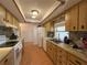 Functional kitchen with wood cabinetry, laminate countertops, and white appliances at 10458 Clingman St, Spring Hill, FL 34608