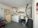Functional laundry area with washer, dryer, utility sink, and storage solutions, offering convenience at 10458 Clingman St, Spring Hill, FL 34608