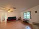 Bright living room with wood floors, a ceiling fan, and a view of the outdoors at 10458 Clingman St, Spring Hill, FL 34608