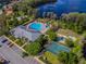 Community pool, playground and tennis court, and lake access with dock from an aerial view at 10925 Oyster Bay Cir, New Port Richey, FL 34654