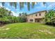 Expansive green backyard featuring lush tropical landscaping and a well-maintained lawn, ideal for outdoor enjoyment at 10925 Oyster Bay Cir, New Port Richey, FL 34654