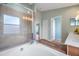 Bright bathroom with a soaking tub and glass-enclosed shower, featuring wood-look flooring at 10925 Oyster Bay Cir, New Port Richey, FL 34654