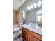 Inviting bathroom featuring wood-look floors, vanity with marble countertop, and bathtub with tile surround at 10925 Oyster Bay Cir, New Port Richey, FL 34654