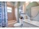 A well-lit bathroom with tiled shower, tub, vanity, and updated fixtures at 10925 Oyster Bay Cir, New Port Richey, FL 34654