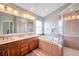 Bright bathroom featuring a double vanity, soaking tub, and glass-enclosed shower at 10925 Oyster Bay Cir, New Port Richey, FL 34654