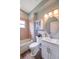 Bathroom with tiled shower, tub, vanity, medicine cabinet and updated lighting at 10925 Oyster Bay Cir, New Port Richey, FL 34654