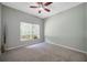 Cozy bedroom with neutral carpet and bright, windowed view at 10925 Oyster Bay Cir, New Port Richey, FL 34654