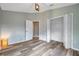 Spacious bedroom featuring wood floors and closet with ample storage at 10925 Oyster Bay Cir, New Port Richey, FL 34654