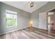 Cozy bedroom featuring wood floors and a bright window with natural light at 10925 Oyster Bay Cir, New Port Richey, FL 34654