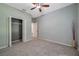 Bedroom boasts neutral paint, plush carpet, ceiling fan and ample closet space at 10925 Oyster Bay Cir, New Port Richey, FL 34654