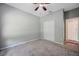 This cozy bedroom features a ceiling fan, neutral paint, and plush carpeting at 10925 Oyster Bay Cir, New Port Richey, FL 34654