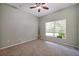 This bedroom is painted in neutral colors and features large window for natural light at 10925 Oyster Bay Cir, New Port Richey, FL 34654