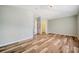 Bright bedroom featuring wood-look floors, ensuite bathroom, and a walk-in closet, perfect for ample storage at 10925 Oyster Bay Cir, New Port Richey, FL 34654