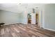 Spacious bedroom with vaulted ceilings, wood-look flooring, and an attached bathroom at 10925 Oyster Bay Cir, New Port Richey, FL 34654
