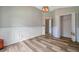 Well-lit bedroom with wood-look floors, decorative wall trim, and closet, perfect for creating a relaxing space at 10925 Oyster Bay Cir, New Port Richey, FL 34654