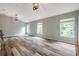 Spacious bonus room featuring modern floors, three large windows, and recessed lighting at 10925 Oyster Bay Cir, New Port Richey, FL 34654