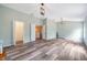 Bonus room features modern floors, decorative lighting, and multiple entry doors at 10925 Oyster Bay Cir, New Port Richey, FL 34654