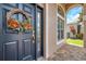 Charming front door with a decorative wreath and a sidelight window at 10925 Oyster Bay Cir, New Port Richey, FL 34654