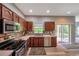 Updated kitchen with stainless steel appliances and view to living area at 10925 Oyster Bay Cir, New Port Richey, FL 34654