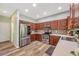 Spacious kitchen featuring wood cabinetry and stainless steel appliances at 10925 Oyster Bay Cir, New Port Richey, FL 34654