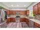 Kitchen featuring stainless steel appliances, wood cabinets, and tile backsplash at 10925 Oyster Bay Cir, New Port Richey, FL 34654