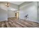 Spacious living room with wood-look floors leading into adjacent rooms, providing an open feel at 10925 Oyster Bay Cir, New Port Richey, FL 34654