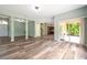 An open-concept living room with modern wood-look floors flowing into the kitchen at 10925 Oyster Bay Cir, New Port Richey, FL 34654