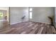 An open living room featuring high ceilings, natural light, and stylish modern wood-look floors at 10925 Oyster Bay Cir, New Port Richey, FL 34654