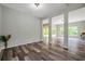 An open-concept living room showcasing wood-look floors and access to an outdoor patio at 10925 Oyster Bay Cir, New Port Richey, FL 34654