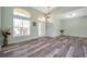 Beautiful living room with high ceilings, large windows, and modern wood-look vinyl plank flooring at 10925 Oyster Bay Cir, New Port Richey, FL 34654