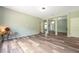 Spacious living room with wood-look flooring and an open-concept layout to the kitchen at 10925 Oyster Bay Cir, New Port Richey, FL 34654