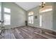 Bright, open living room showcasing high ceilings, natural light, and modern wood-look floors at 10925 Oyster Bay Cir, New Port Richey, FL 34654