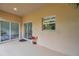 Covered patio with neutral colors and sliding glass doors at 10925 Oyster Bay Cir, New Port Richey, FL 34654