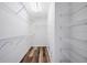 A bright walk-in closet featuring wire shelving and wood-look flooring at 10925 Oyster Bay Cir, New Port Richey, FL 34654