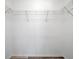 A white and empty walk-in closet with minimal wire shelving and wood-look flooring at 10925 Oyster Bay Cir, New Port Richey, FL 34654