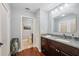 Bathroom features marble countertops, a wood vanity, and a doorway leading to a toilet room at 11505 Cerca Del Rio, Temple Terrace, FL 33617