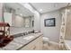 Bathroom featuring a tub, shower combo, granite countertop and framed mirror at 11505 Cerca Del Rio, Temple Terrace, FL 33617